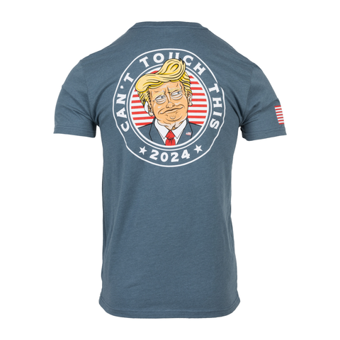 rear view of indigo Can't Touch This Tee with graphic of trump with patched ear surrounded by text "CAN'T TOUCH THIS 2024" with American flag on right sleeve